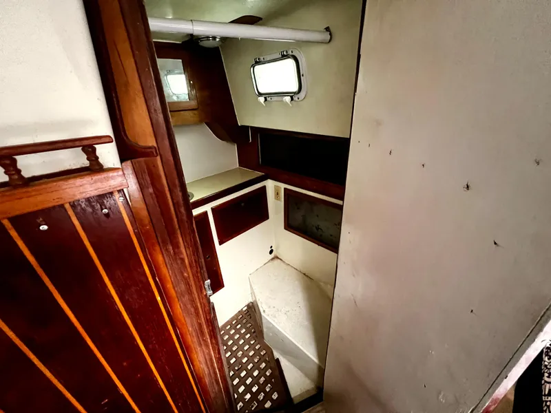 Slide: The Image of 1974 Irwin 37 Center Cockpit interior with wooden paneling and small window. - 33