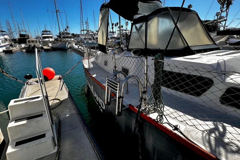 Slide: The Image of 1974 Irwin 37 Center Cockpit yacht docked in a marina, surrounded by other boats. - 38