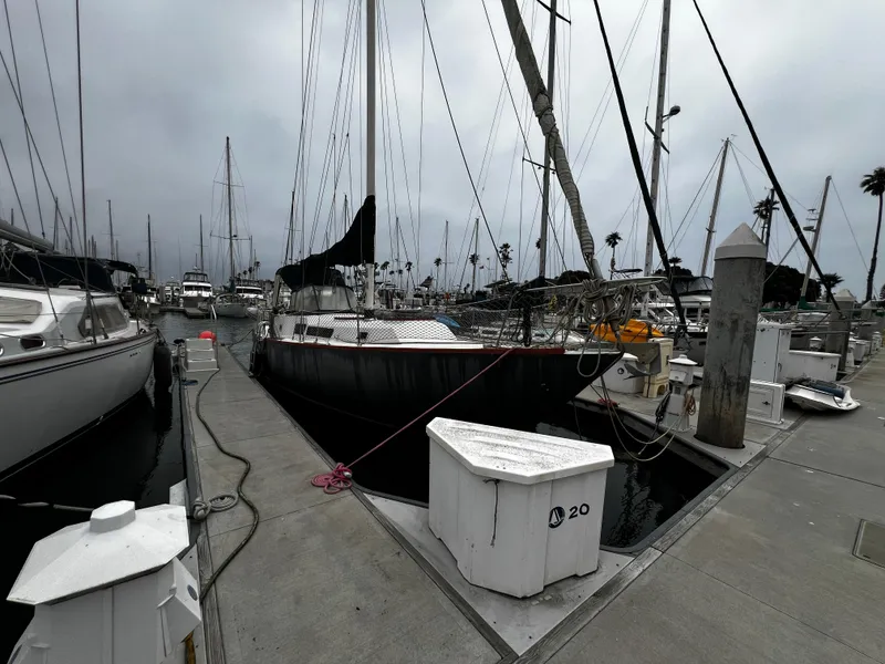 Slide: The Image of 1974 Irwin 37 Center Cockpit sailboat docked at a marina under cloudy skies. - 4