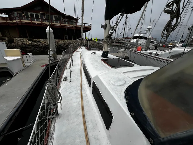 Slide: The Image of 1974 Irwin 37 Center Cockpit sailboat docked at marina, overcast sky. - 8