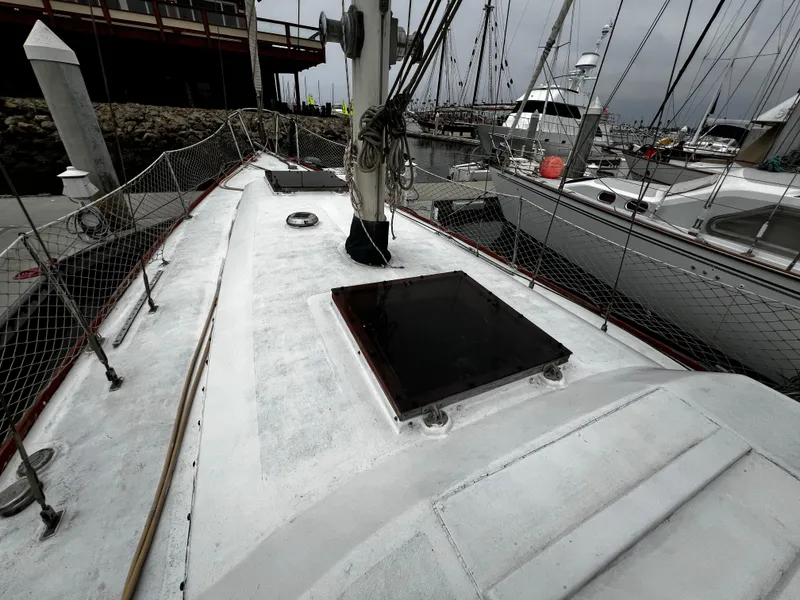Slide: The Image of 1974 Irwin 37 Center Cockpit sailboat docked at marina, overcast sky. - 9