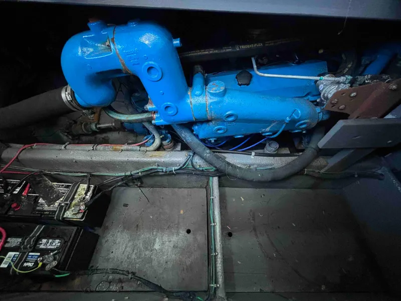 Slide: The Image of Engine compartment of a 1988 Luhrs Tournament 400 Convertible with visible blue engine components. - 13