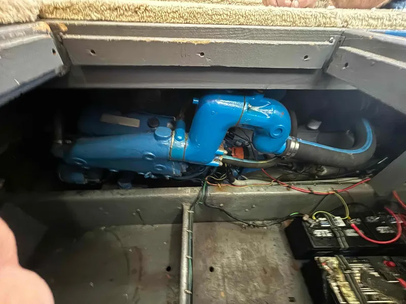 Slide: The Image of Engine compartment of a 1988 Luhrs Tournament 400 Convertible with visible blue engine components. - 14