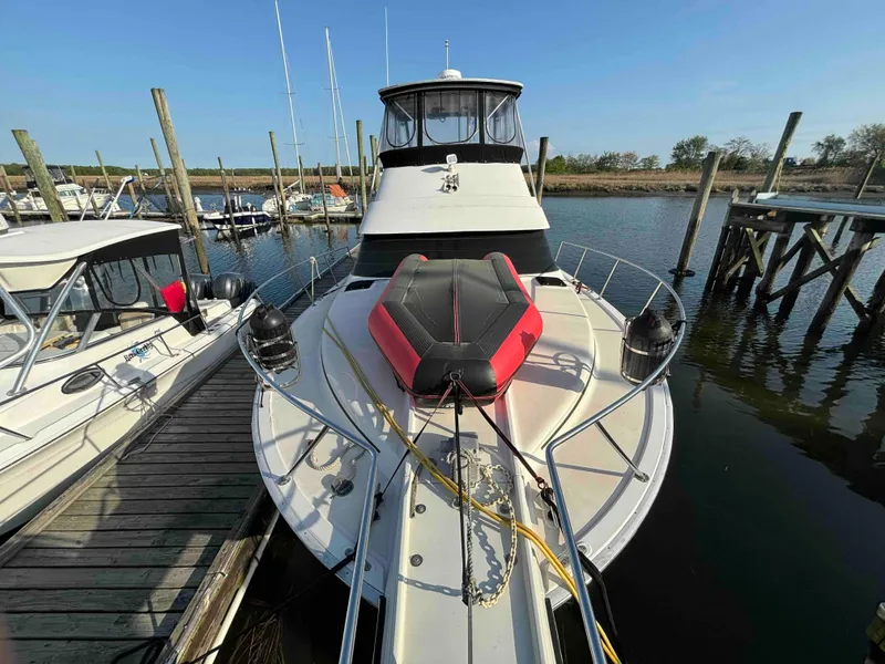 Slide: The Image of 1988 Luhrs Tournament 400 Convertible docked at marina, front view. - 2