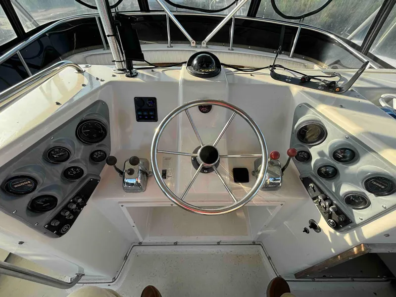 Slide: The Image of 1988 Luhrs Tournament 400 Convertible helm with gauges and steering wheel. - 4