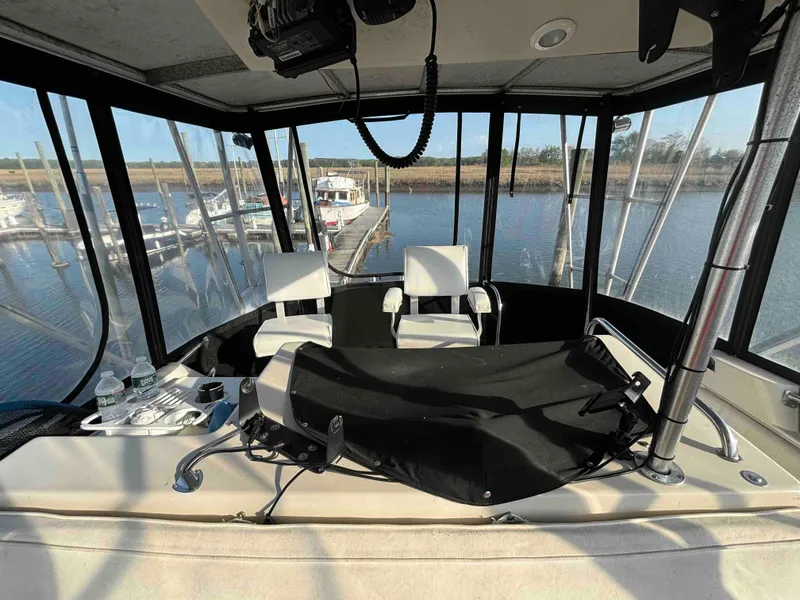 Slide: The Image of 1988 Luhrs Tournament 400 Convertible boat interior with helm and seating at marina. - 5