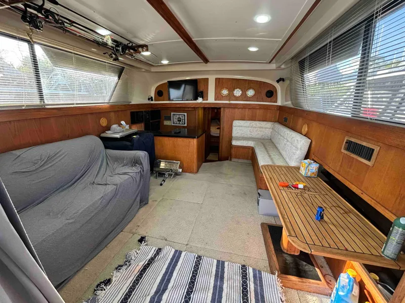 Slide: The Image of 1988 Luhrs Tournament 400 Convertible interior with cozy seating, wooden accents, and modern amenities. - 7