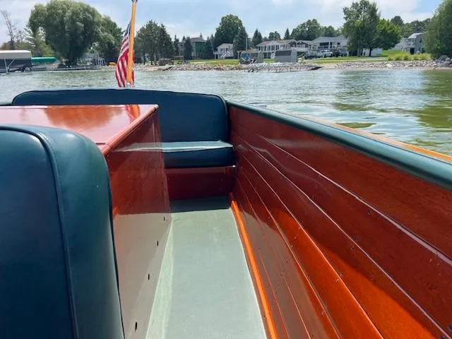 Slide: The Image of 1956 Chris-Craft 23 Continental boat interior with wooden finish on a lake. - 11