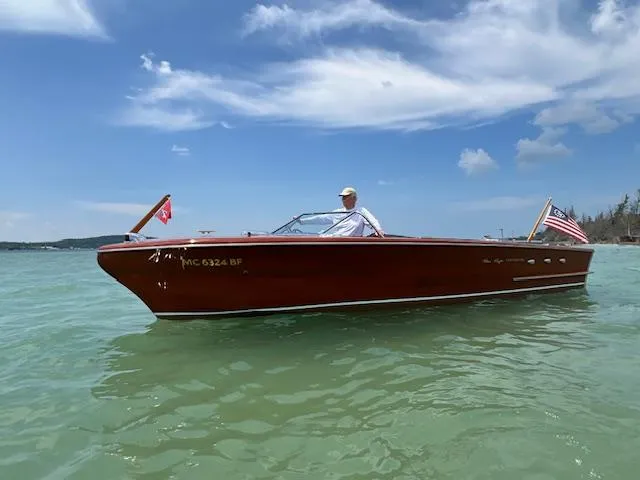 Slide: The Image of 1956 Chris-Craft 23 Continental boat on clear water under a blue sky. - 21