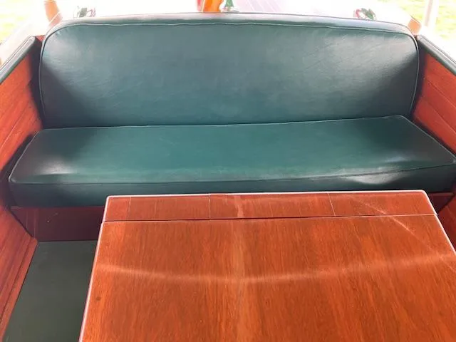 Slide: The Image of 1956 Chris-Craft 23 Continental interior with green leather seating and wooden table. - 22