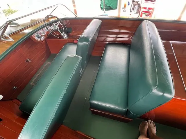 Slide: The Image of 1956 Chris-Craft 23 Continental interior with green leather seats and wooden dashboard. - 26