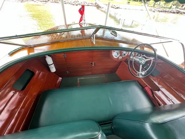 Slide: The Image of 1956 Chris-Craft 23 Continental boat interior with classic wooden dashboard and green seating. - 27