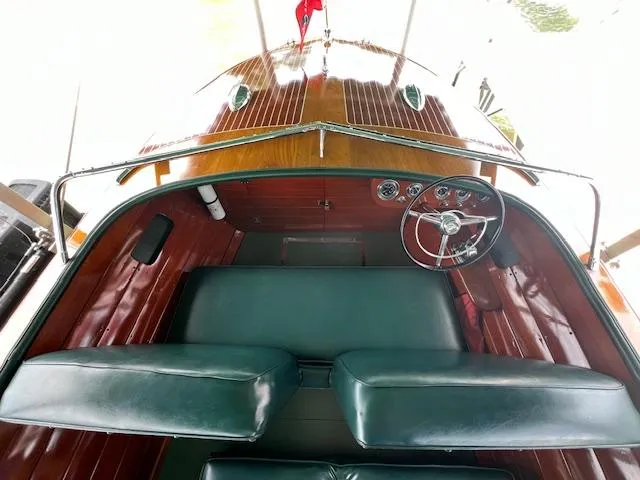 Slide: The Image of 1956 Chris-Craft 23 Continental boat interior with classic wooden dashboard and green seating. - 28