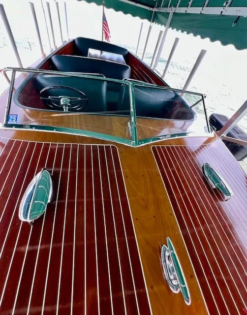 Slide: The Image of 1956 Chris-Craft 23 Continental boat with polished wood finish and classic design. - 6