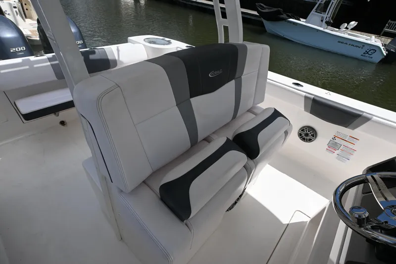 Slide: The Image of 2020 Robalo R272 Center Console boat interior with cushioned seating and steering wheel. - 10