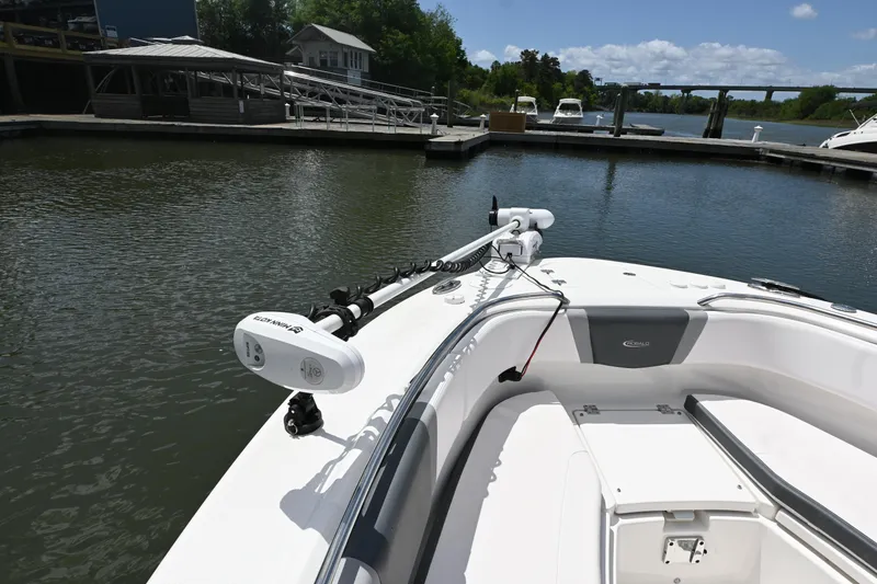 Slide: The Image of 2020 Robalo R272 Center Console boat docked in a marina under clear skies. - 11