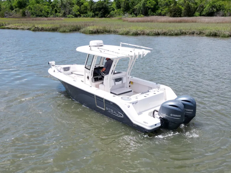 Slide: The Image of 2020 Robalo R272 Center Console boat cruising on a calm river. - 2