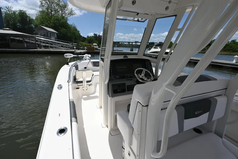 Slide: The Image of 2020 Robalo R272 Center Console boat docked, featuring sleek design and modern controls. - 7