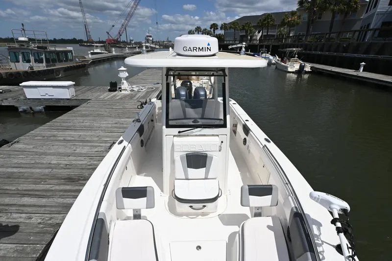 Slide: The Image of 2020 Robalo R272 Center Console boat docked at marina, featuring Garmin equipment. - 8