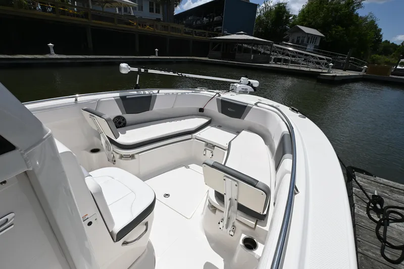 Slide: The Image of 2020 Robalo R272 Center Console boat interior at dock, featuring seating and storage. - 9