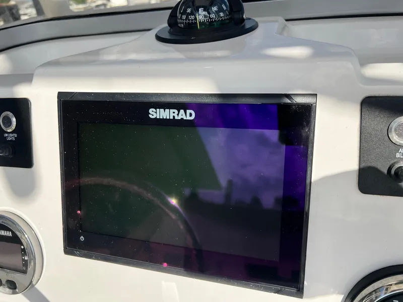 Slide: The Image of Simrad display on 2022 Robalo 206 Cayman boat dashboard with compass and controls. - 12