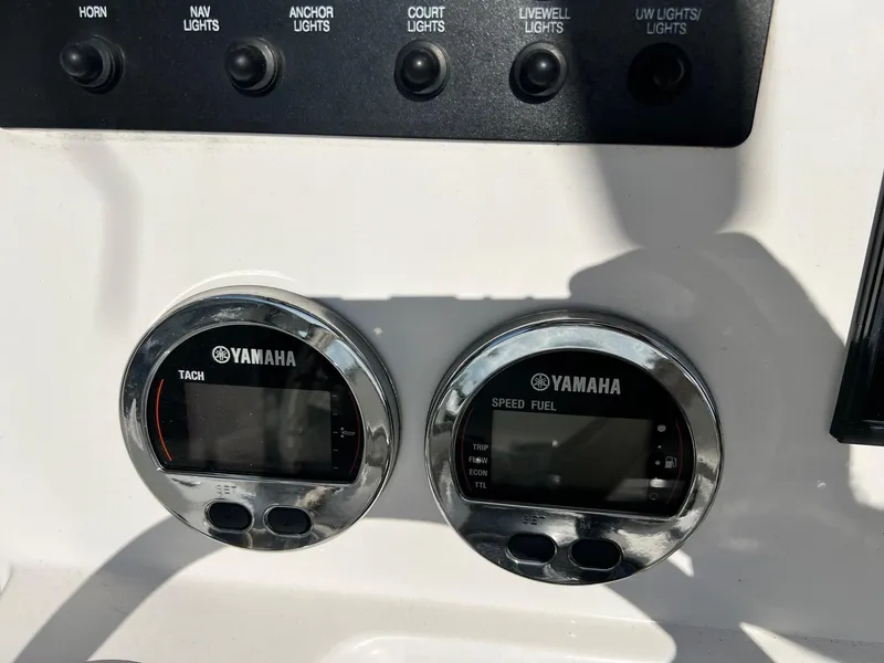 Slide: The Image of Yamaha gauges on 2022 Robalo 206 Cayman boat dashboard with control switches. - 13