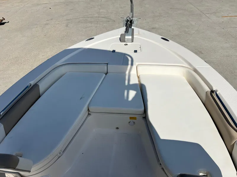 Slide: The Image of 2022 Robalo 206 Cayman boat interior with cushioned seating and anchor. - 14