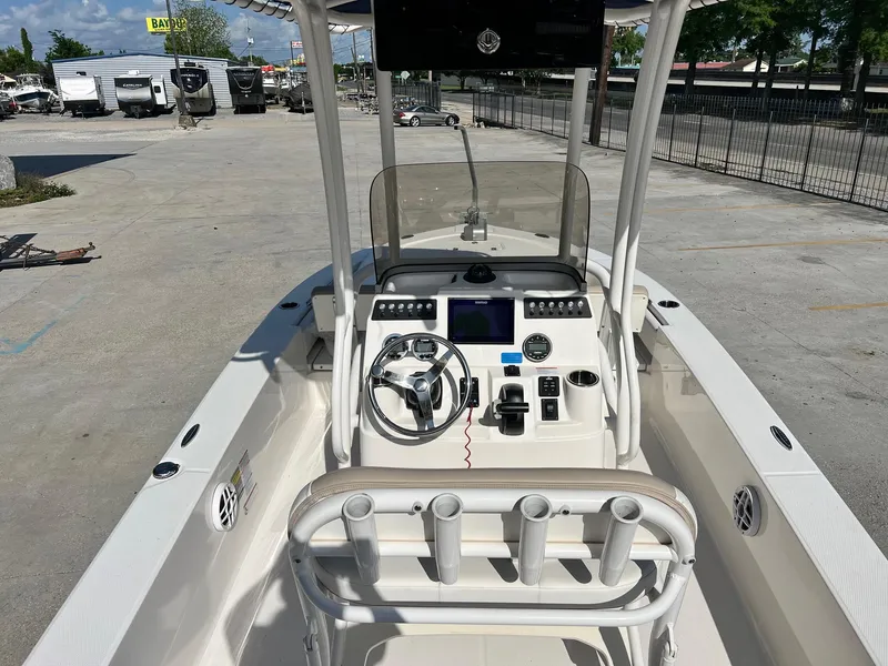 Slide: The Image of 2022 Robalo 206 Cayman boat interior with steering console and rod holders. - 6