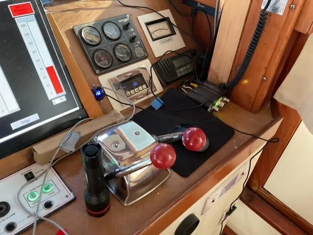 Slide: The Image of Control panel of a 1988 Jefferson 42 Sundeck boat with throttle levers and gauges. - 10