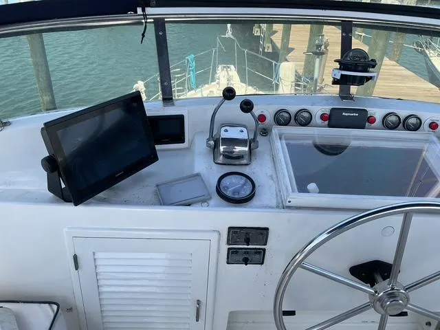 Slide: The Image of Cockpit of 1988 Jefferson 42 Sundeck yacht with navigation equipment and steering wheel. - 11