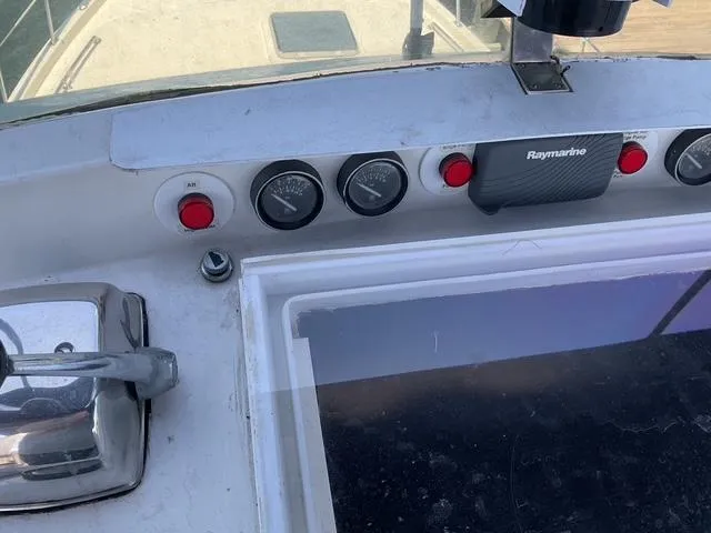 Slide: The Image of Control panel of a 1988 Jefferson 42 Sundeck boat with gauges and Raymarine device. - 14