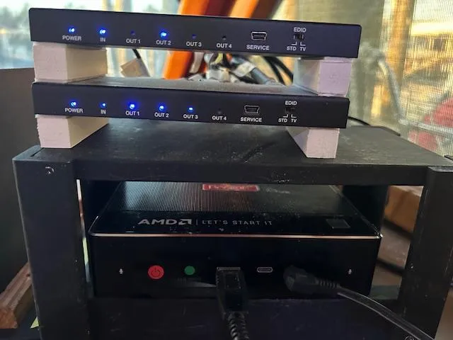 Slide: The Image of Stacked electronic devices with blue LED indicators and AMD hardware on a shelf. - 16