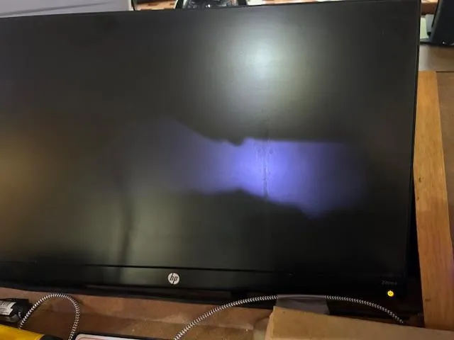 Slide: The Image of A dark HP monitor with a faint purple glow on the screen. - 17