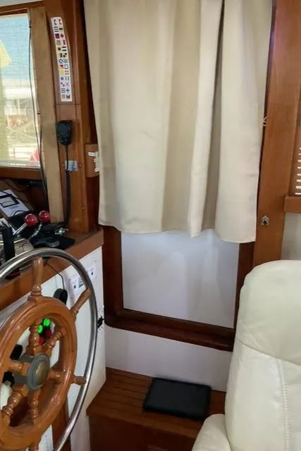 Slide: The Image of Interior helm of 1988 Jefferson 42 Sundeck with wooden steering wheel and controls. - 20