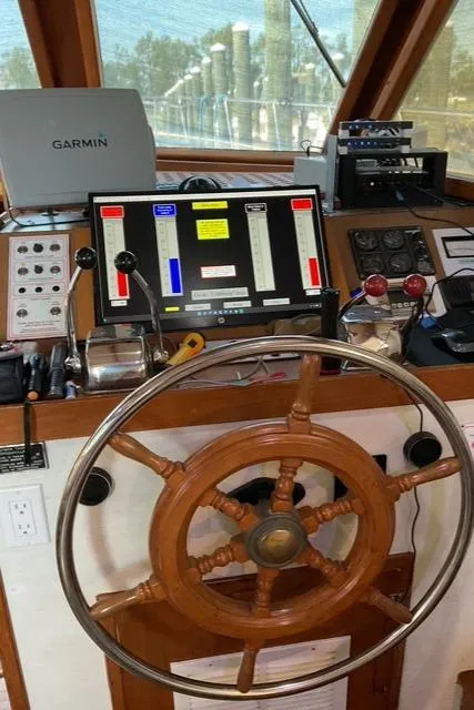Slide: The Image of Helm of 1988 Jefferson 42 Sundeck with navigation equipment and wooden steering wheel. - 21