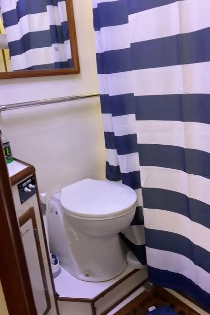 Slide: The Image of Bathroom interior of 1988 Jefferson 42 Sundeck yacht with striped shower curtain. - 23
