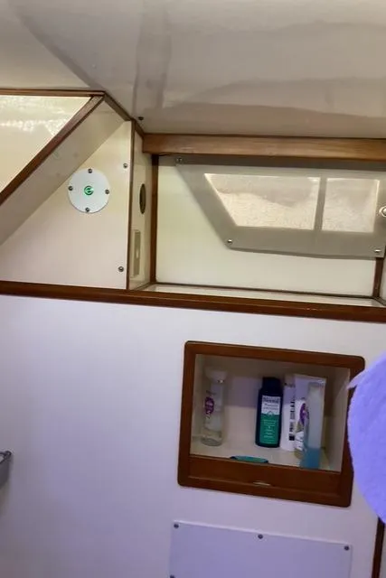 Slide: The Image of Interior of 1988 Jefferson 42 Sundeck boat with window and storage shelf. - 24