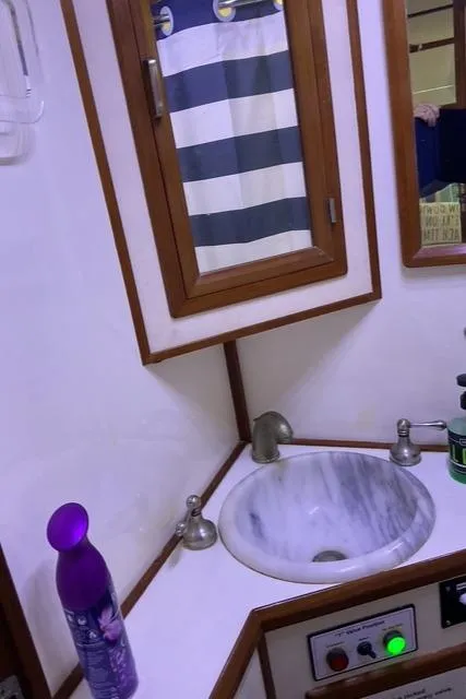 Slide: The Image of 1988 Jefferson 42 Sundeck bathroom with sink, mirror, and toiletries. - 25