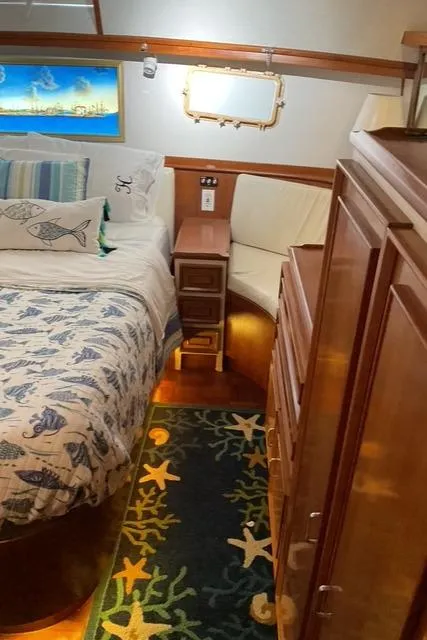 Slide: The Image of 1988 Jefferson 42 Sundeck interior with nautical-themed bedding and decor. - 27