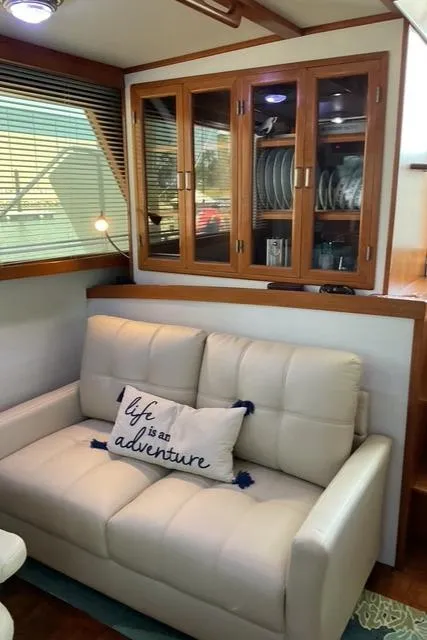 Slide: The Image of 1988 Jefferson 42 Sundeck interior with white sofa, decorative pillow, and wooden cabinet. - 31