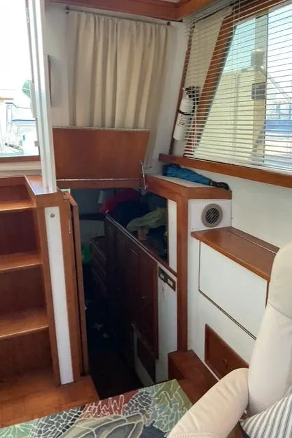 Slide: The Image of 1988 Jefferson 42 Sundeck interior with wooden stairs and cozy cabin space. - 32