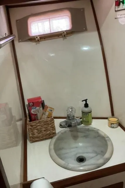 Slide: The Image of 1988 Jefferson 42 Sundeck bathroom with sink, toiletries, and window. - 40