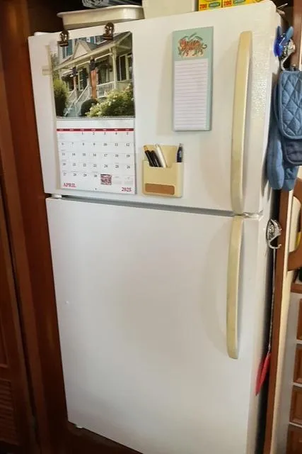 Slide: The Image of White refrigerator with calendar and notepad, Jefferson 42 Sundeck, 1988 model. - 42