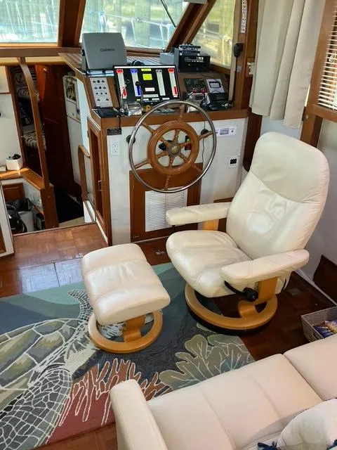 Slide: The Image of 1988 Jefferson 42 Sundeck interior with captain's chair, steering wheel, and control panel. - 44