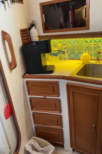 Slide: The Image of 1988 Jefferson 42 Sundeck kitchen with coffee maker, colorful backsplash, and wooden cabinets. - 45