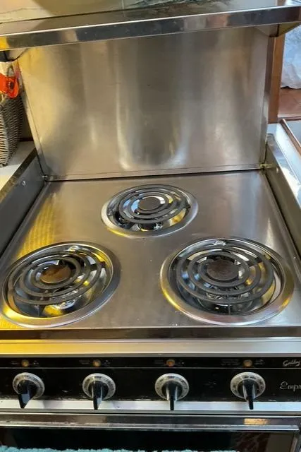 Slide: The Image of Stainless steel electric stove with three burners on a 1988 Jefferson 42 Sundeck yacht. - 47