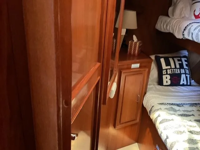 Slide: The Image of Cozy cabin interior of 1988 Jefferson 42 Sundeck with wooden furnishings and nautical decor. - 5