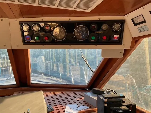 Slide: The Image of Control panel of a 1988 Jefferson 42 Sundeck boat, featuring gauges and switches. - 7
