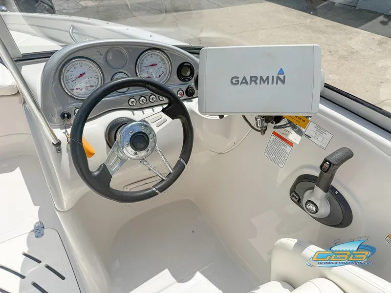 Slide: The Image of 2007 Tahoe Q7i SF boat dashboard with Garmin GPS and steering wheel. - 12