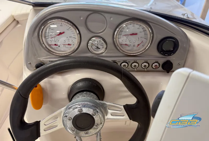 Slide: The Image of Steering wheel and dashboard of 2007 Tahoe Q7i SF boat with gauges and controls. - 13